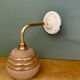 Vintage pink and gold frosted glass globe wall light.