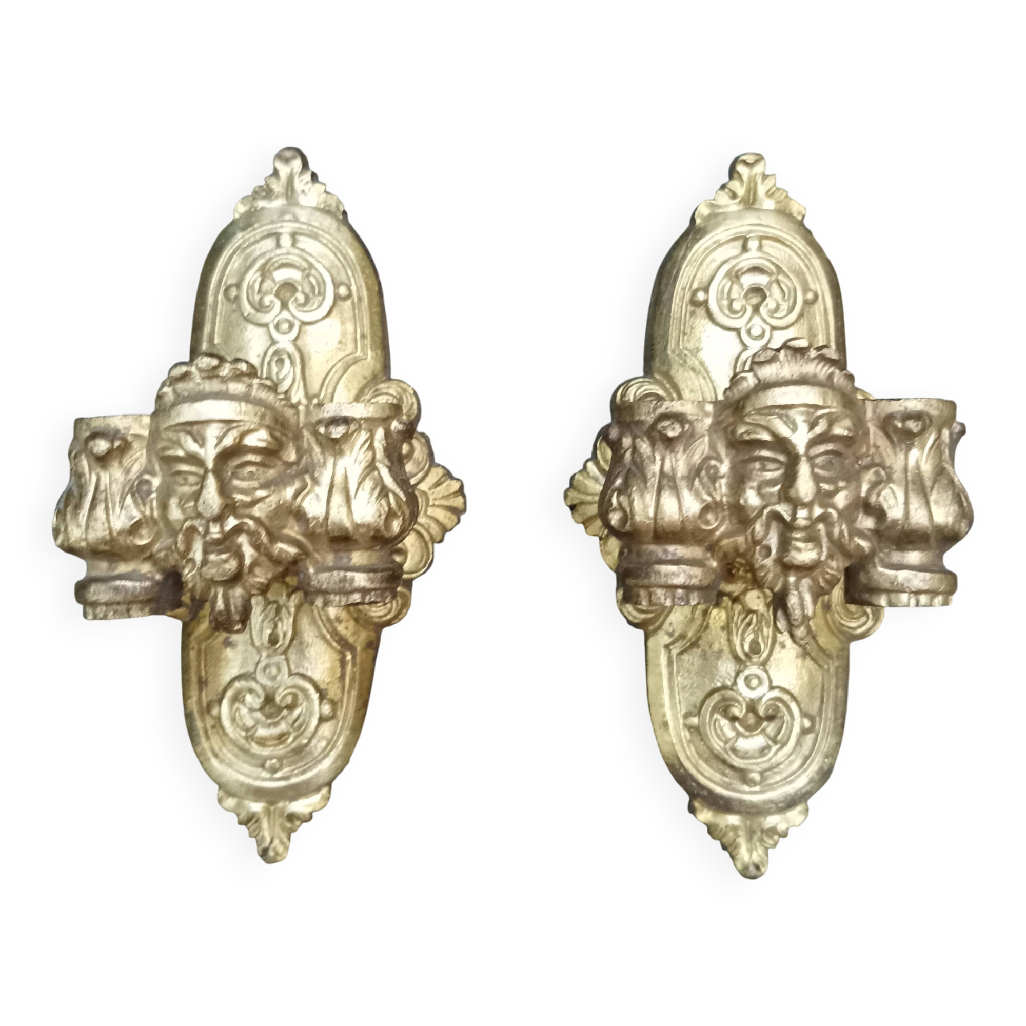 Pair of bronze wall sconces with mask, signed L. Pinet, Art Nouveau period.