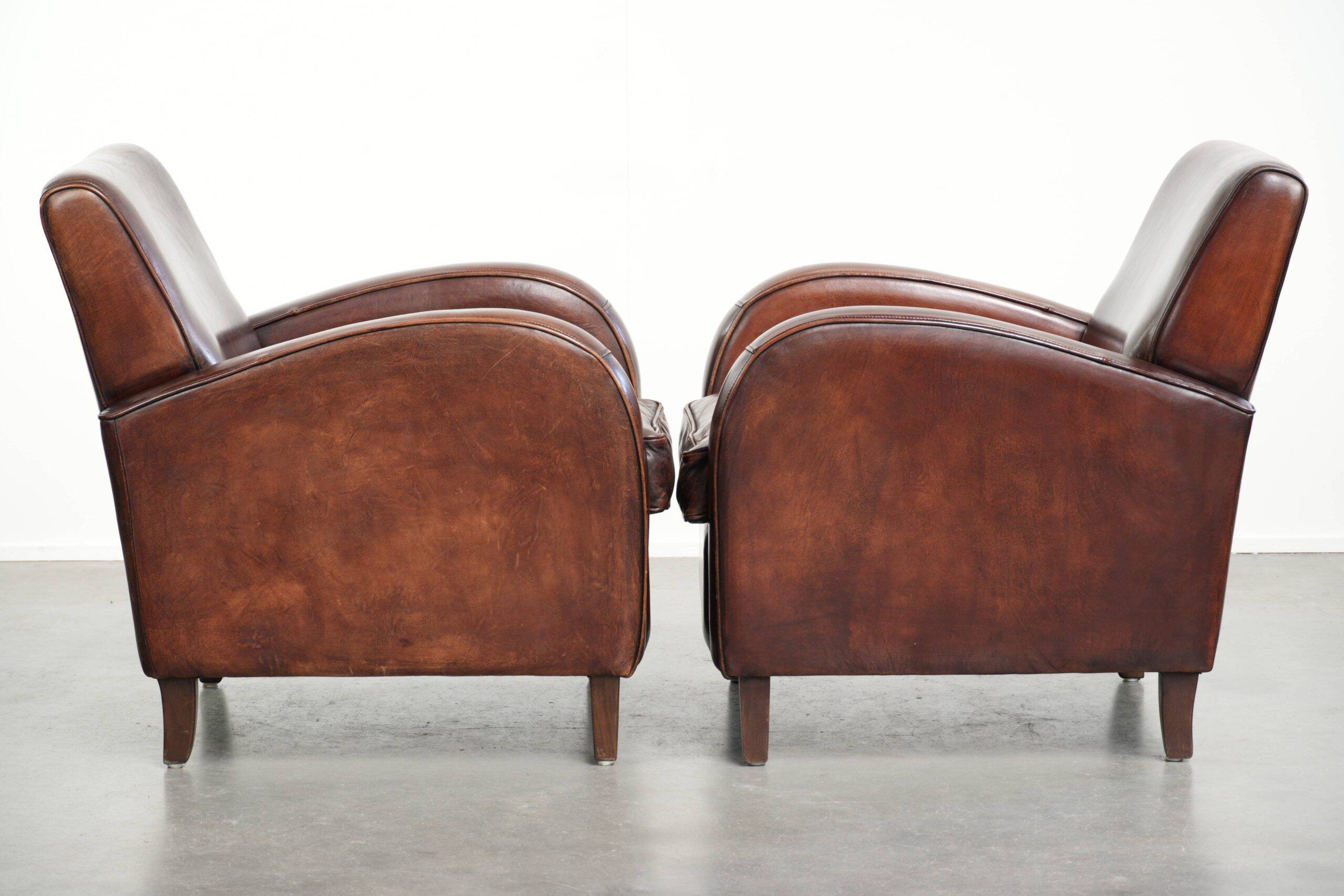 Dark cognac-coloured set of 2 sheepskin armchairs with a sleek design