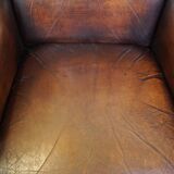 Luxurious sheepskin armchair with a fixed seat cushion and high seating comfort