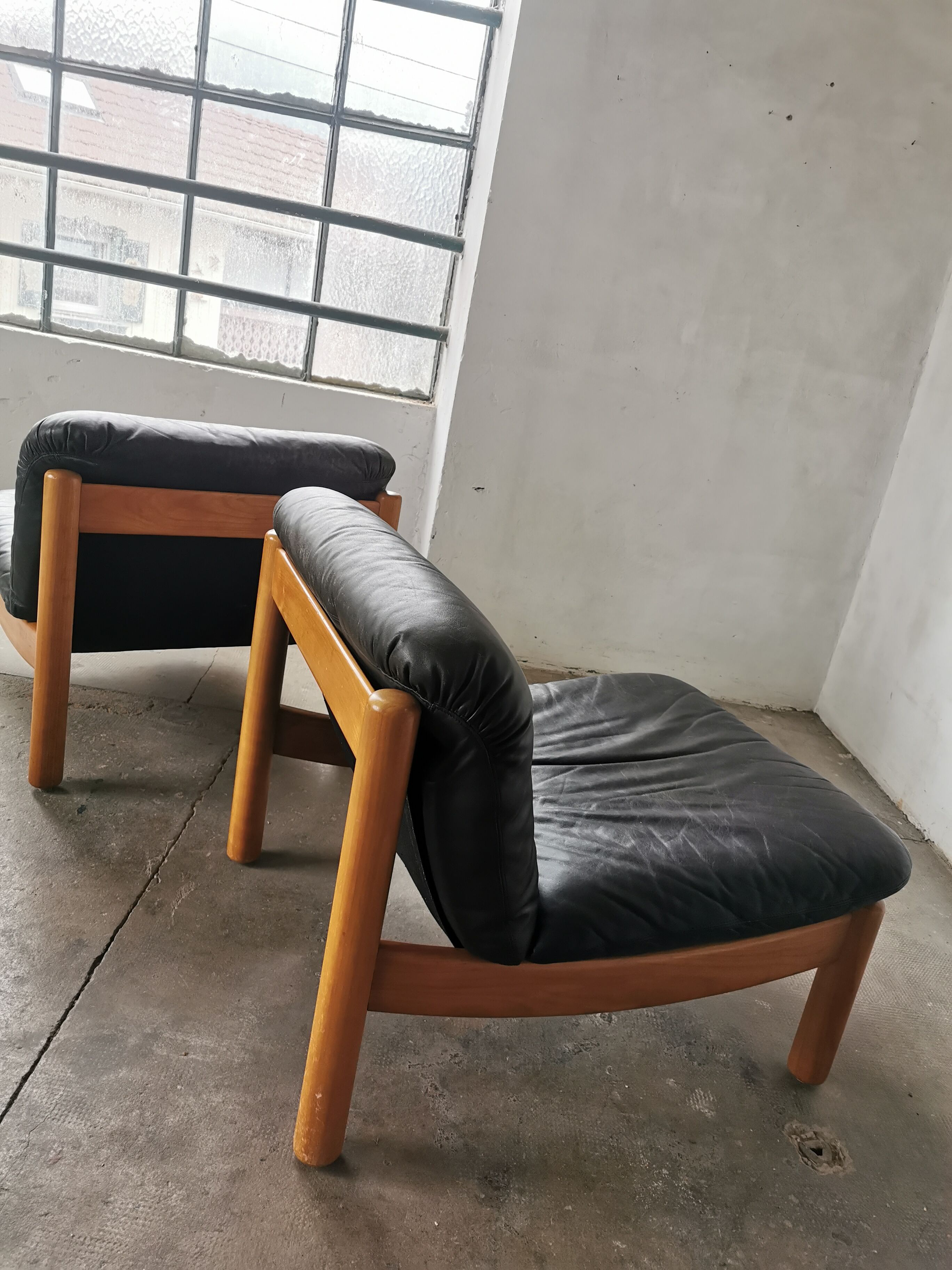 Pair of designer leather armchairs 80s