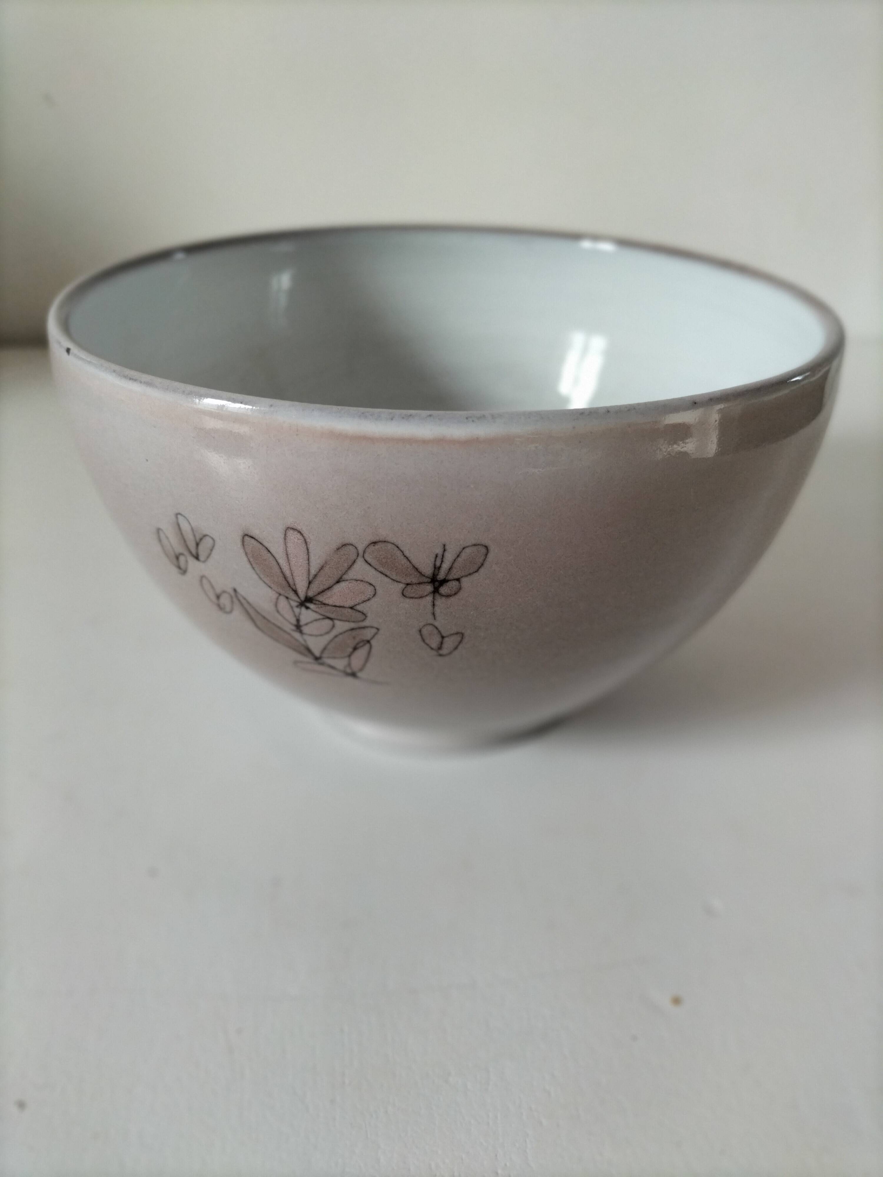 Glazed earthenware bowl, Millian pottery, France, stylised floral decoration.