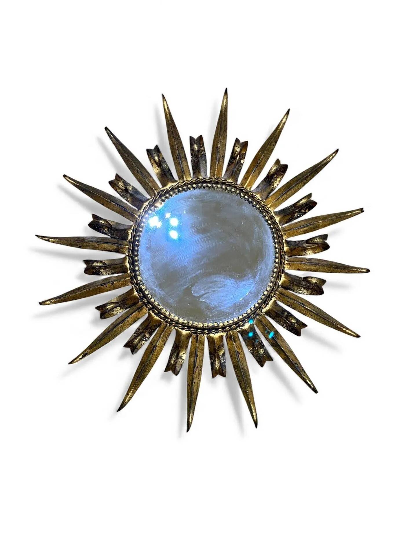 Golden and patinated metal sun mirror