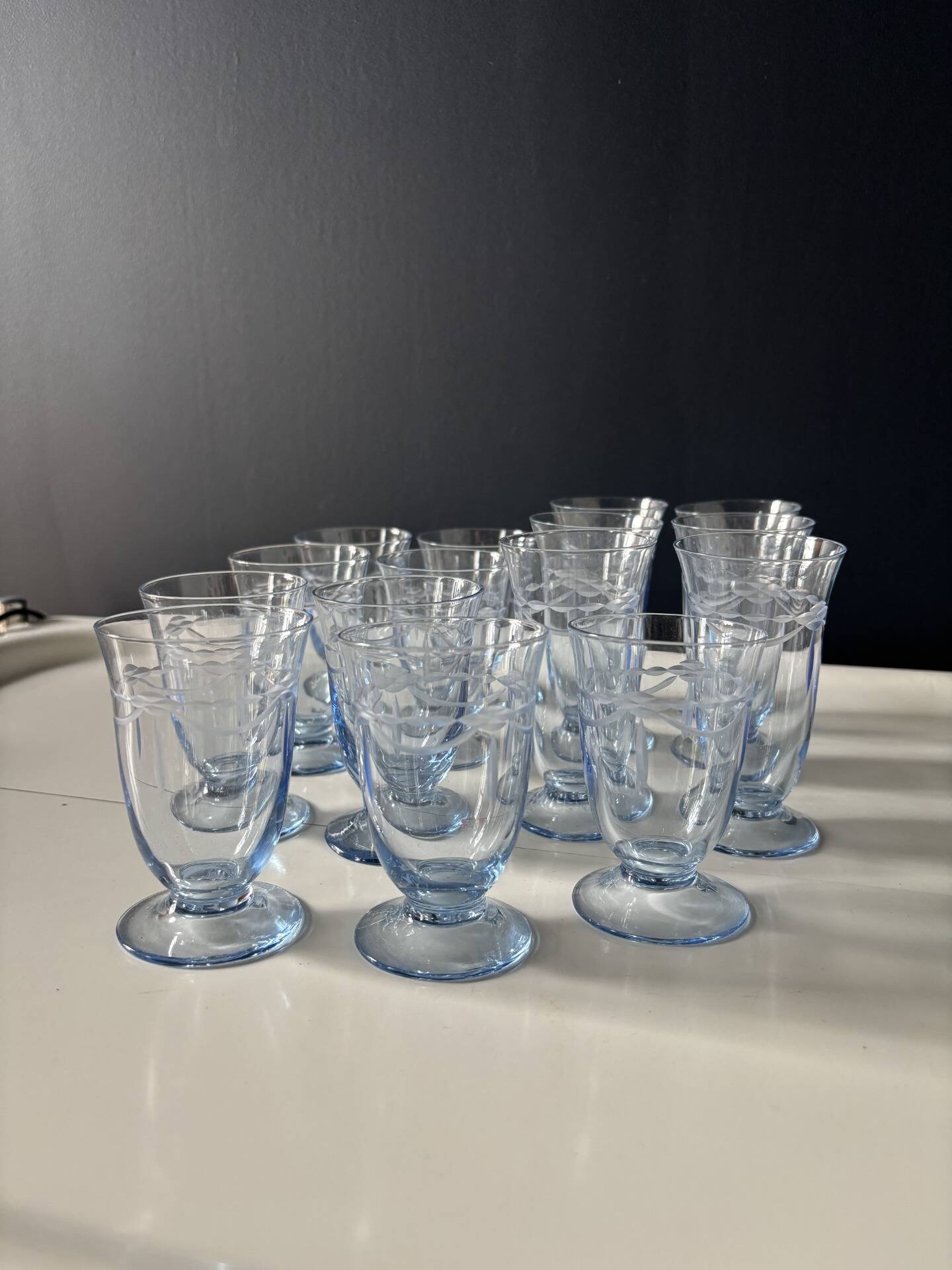 Set of 32 vintage glacier blue engraved stemmed glasses.