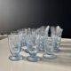 Set of 32 vintage glacier blue engraved stemmed glasses.