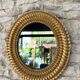 Pair of antique oval mirrors gilded with gold leaf and mercury.