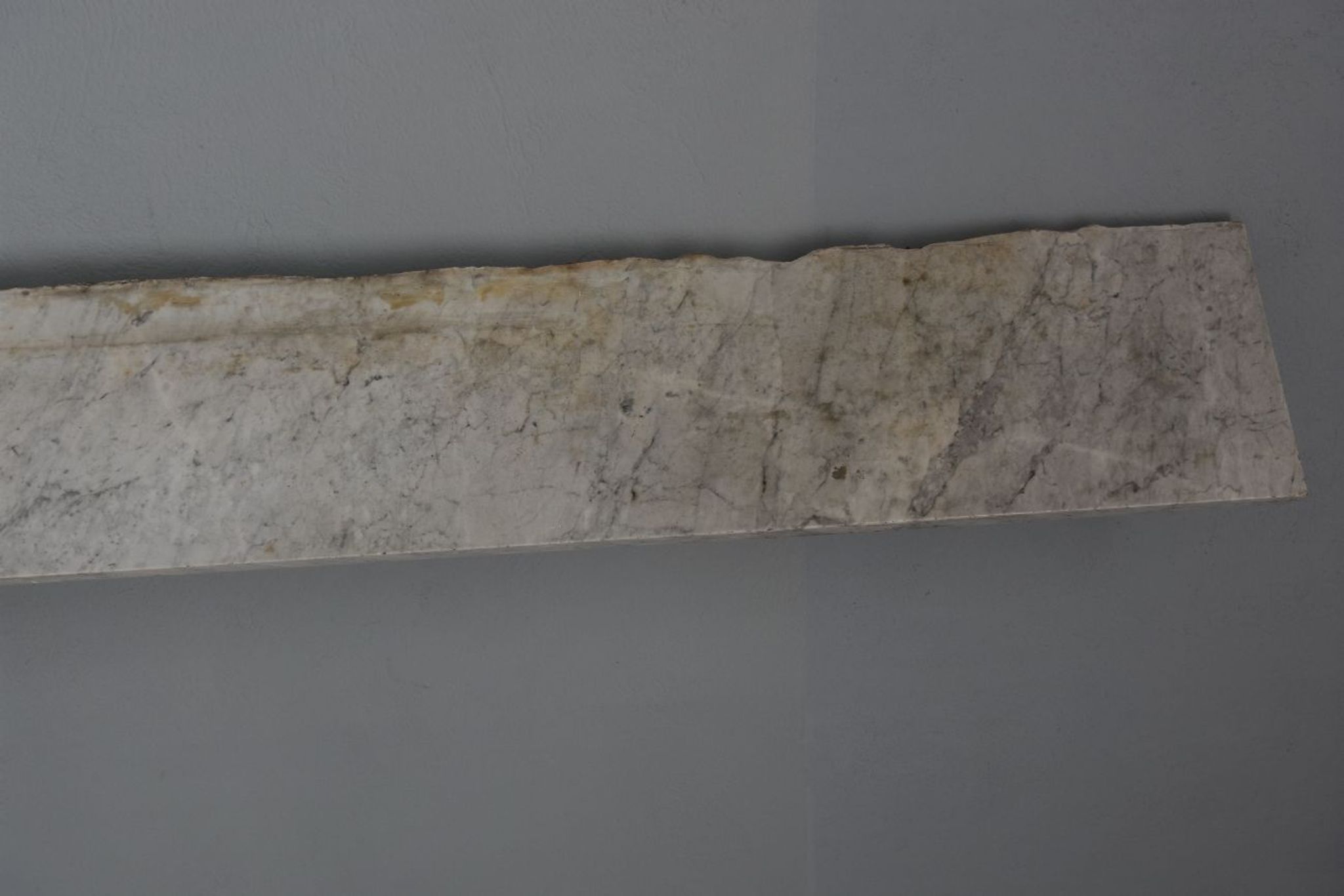 Old fireplace in white marble veined Louis XVI