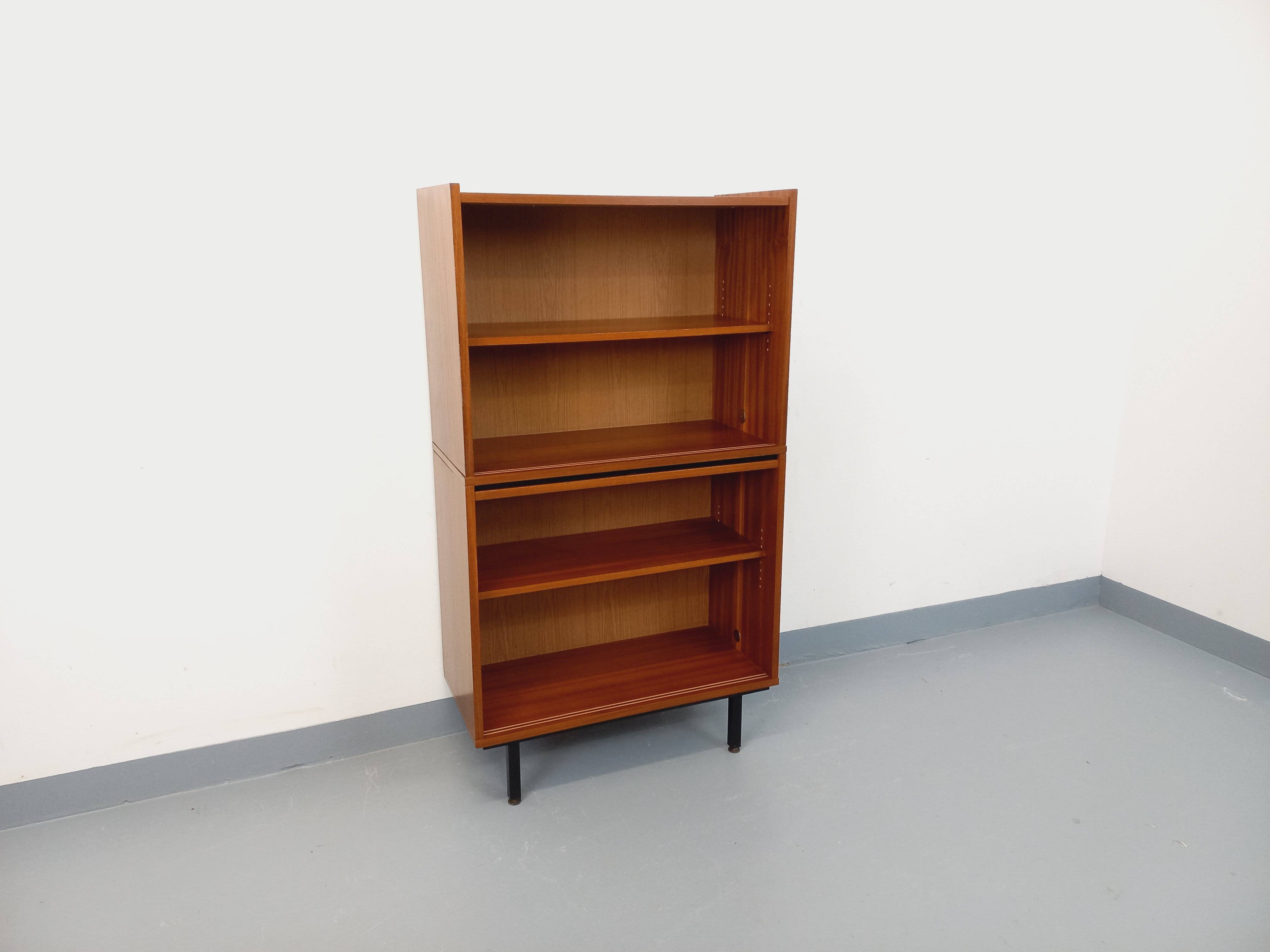 Vintage wooden bookshelf in teak style from the 1960s.