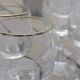 Set of 15 engraved crystal glasses with a gold rim.