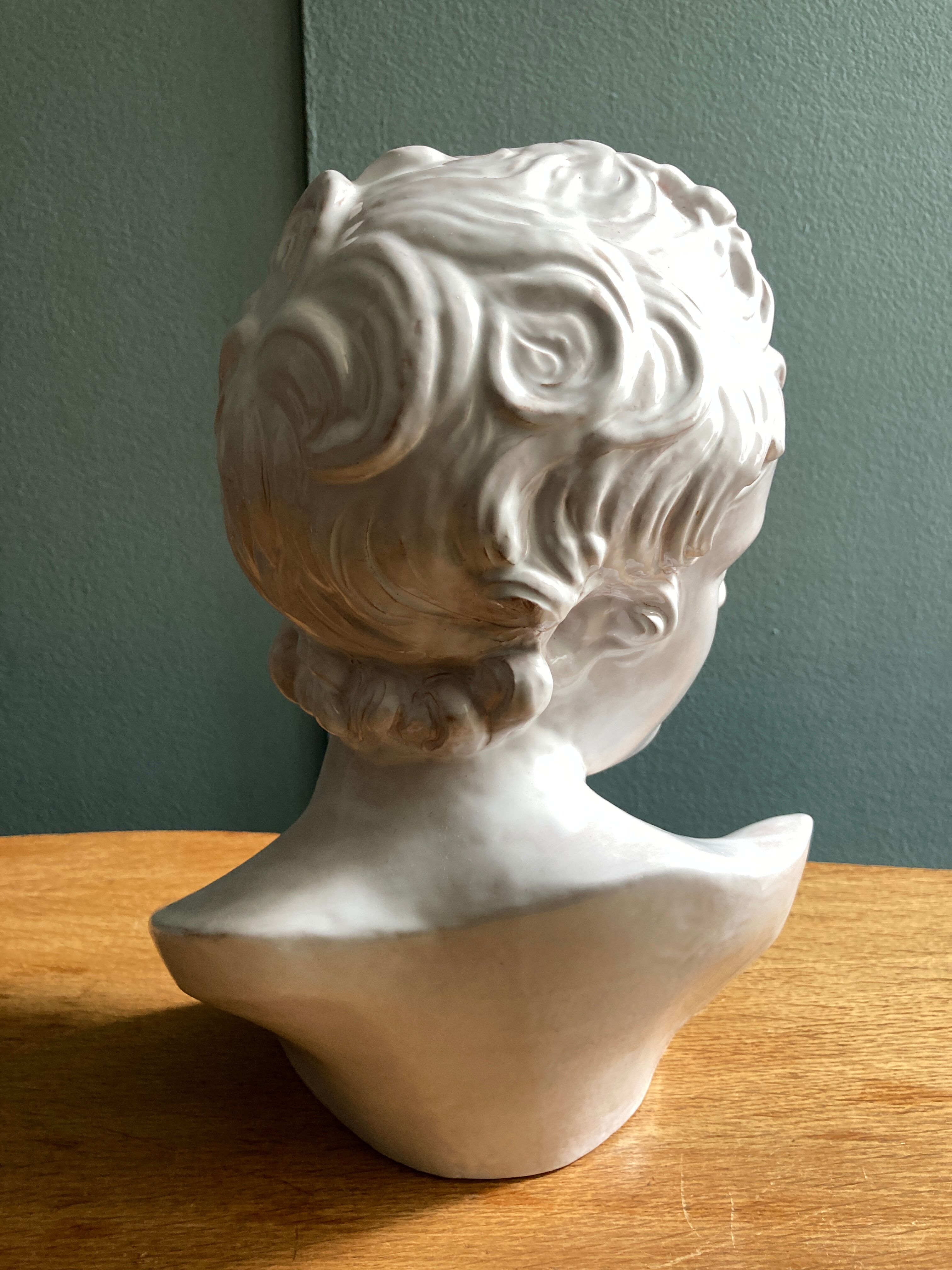 White enamelled terracotta Eros bust