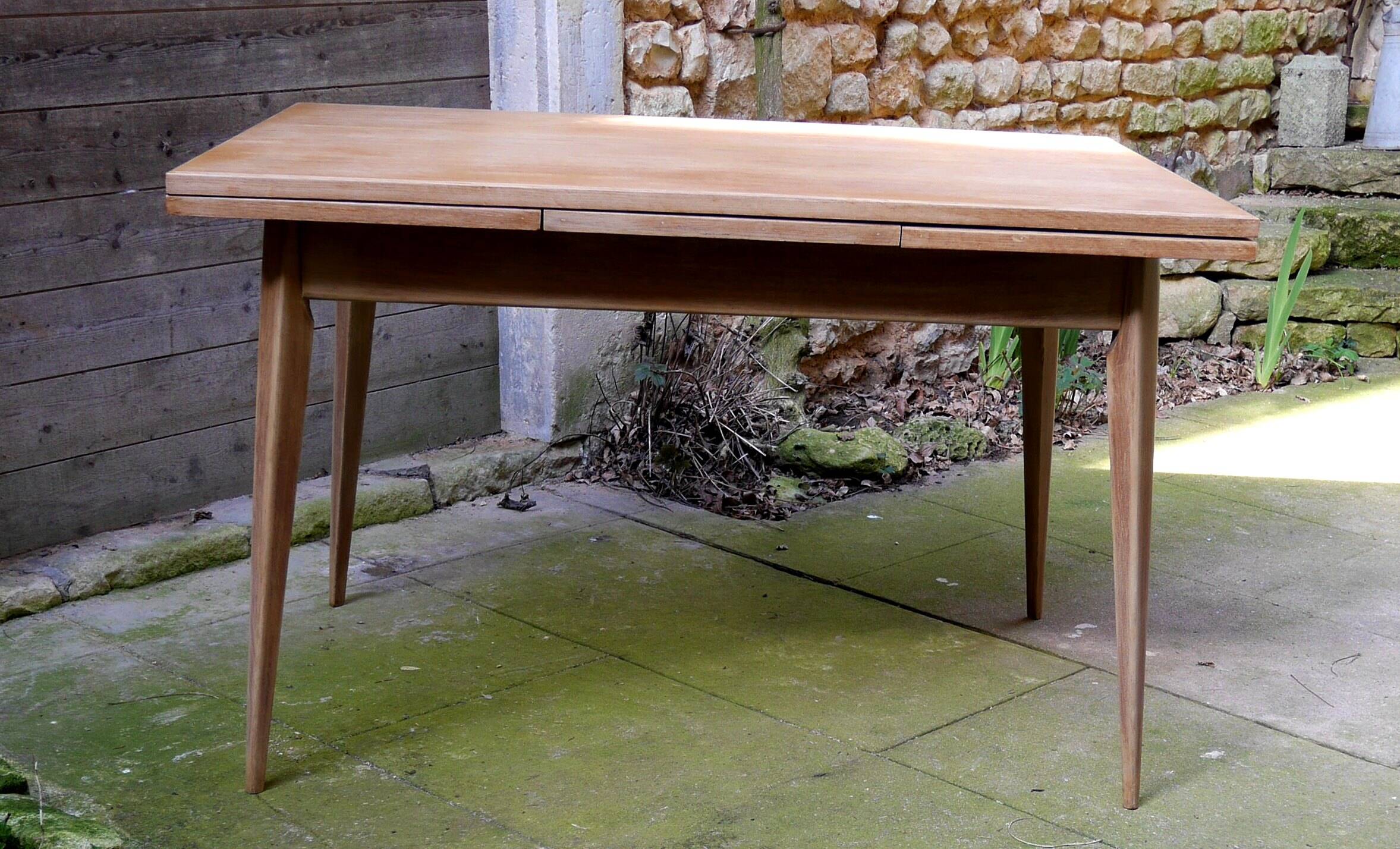 wooden dining table with compass legs and extensions