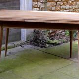 wooden dining table with compass legs and extensions