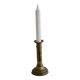 Antique brass candlestick with a push button.