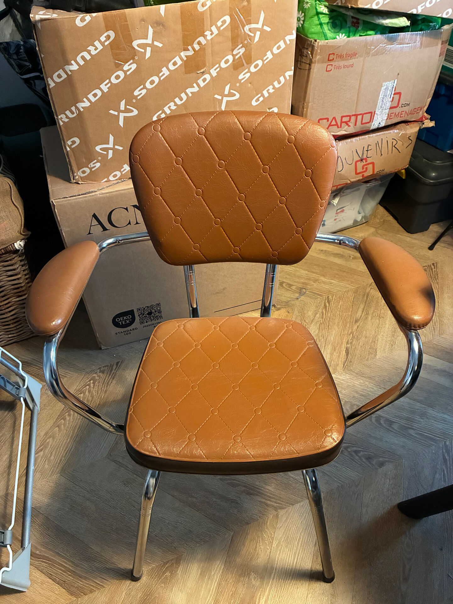 Armchair with armrests from the 70s in Skai and chrome.