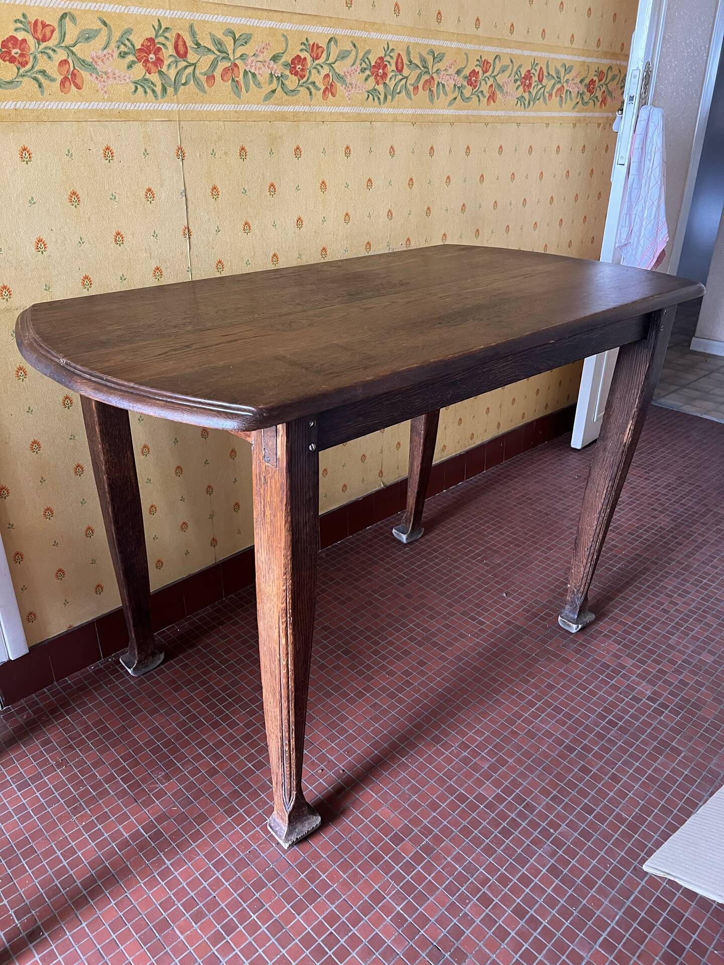 Vintage antique oak table with ornate legs.