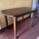 Vintage antique oak table with ornate legs.