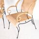 Pair of wicker and blackened iron armchairs