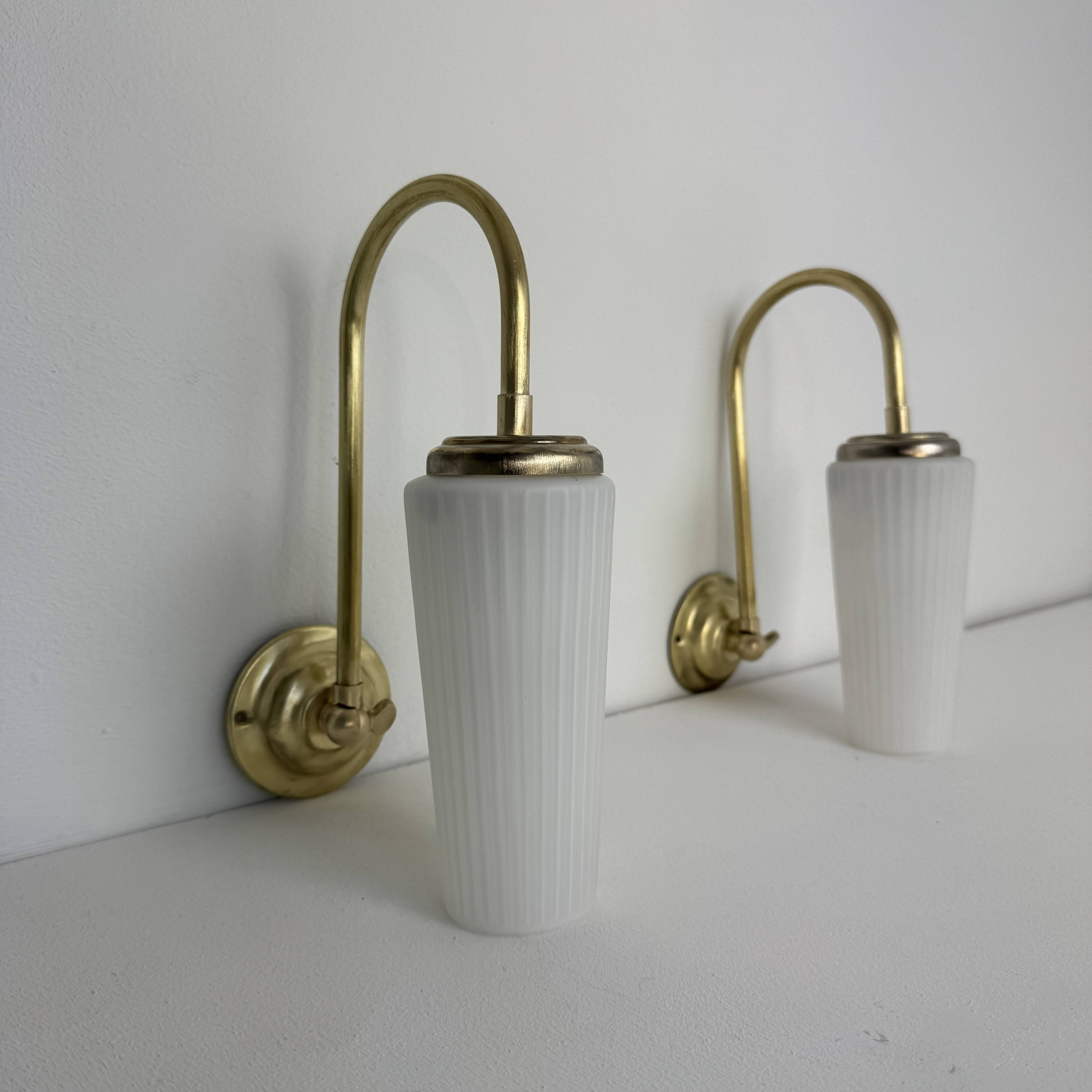 A pair of vintage opaline and brass wall lights