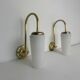 A pair of vintage opaline and brass wall lights