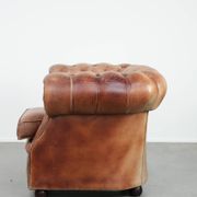 Chesterfield armchair in English style made of cowhide leather