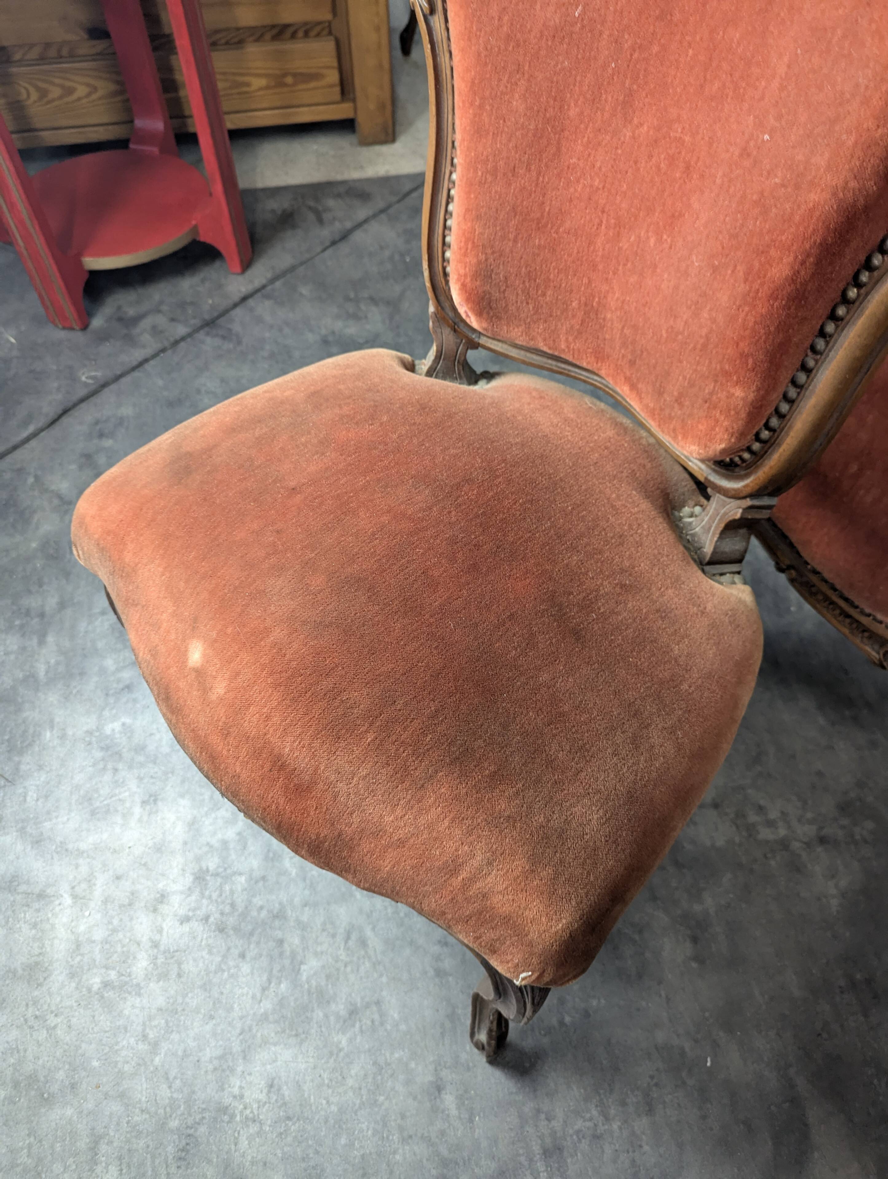 Louis XV style salon in carved walnut with orange velvet, seven pieces.