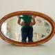 Antique oval mirror with beveled glass in wood and stucco, 19th century