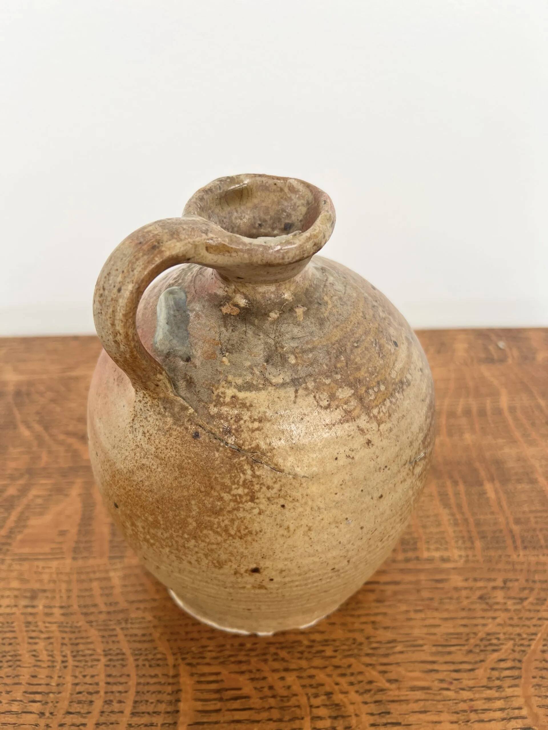 Small antique stoneware jar with handle