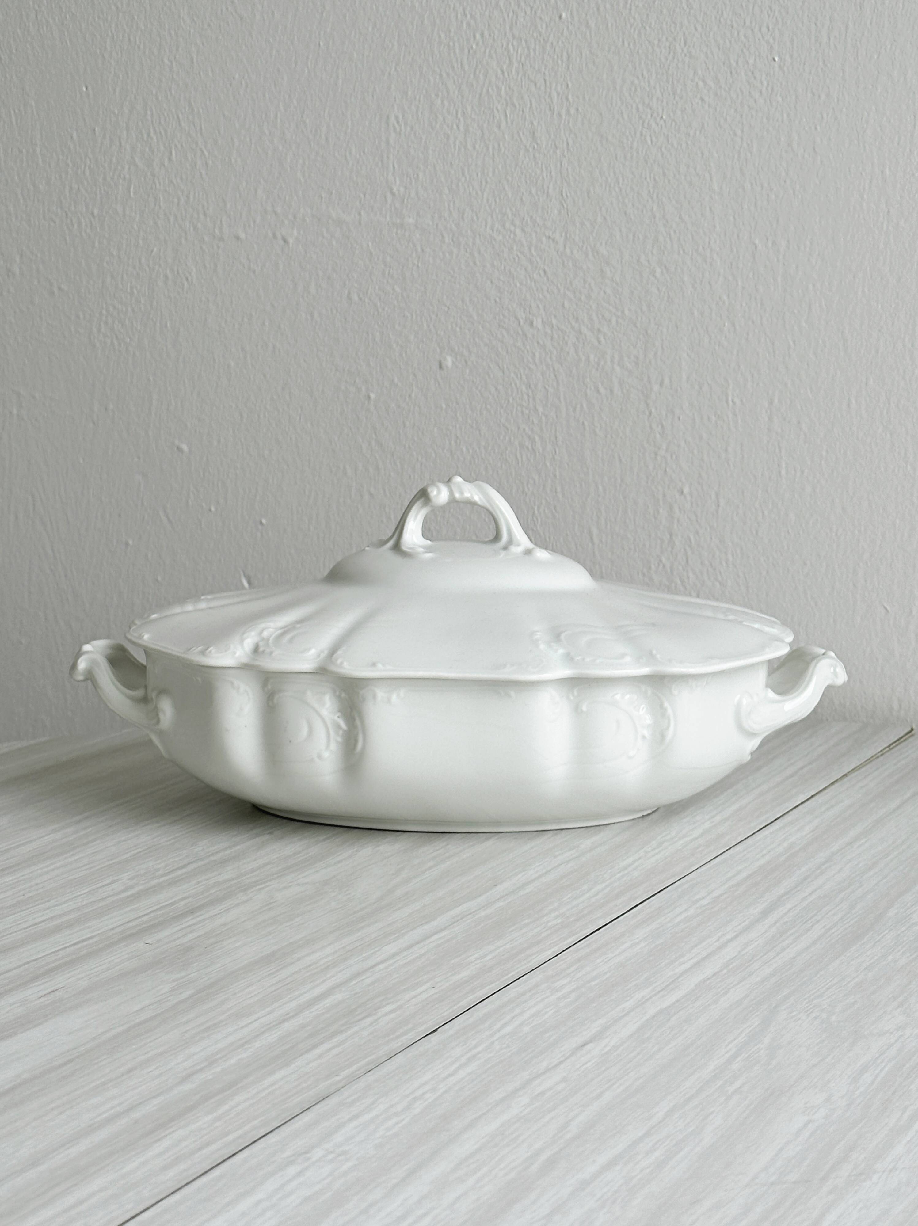 White fine porcelain soup tureen with relief decoration.