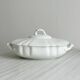 White fine porcelain soup tureen with relief decoration.