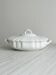 White fine porcelain soup tureen with relief decoration.