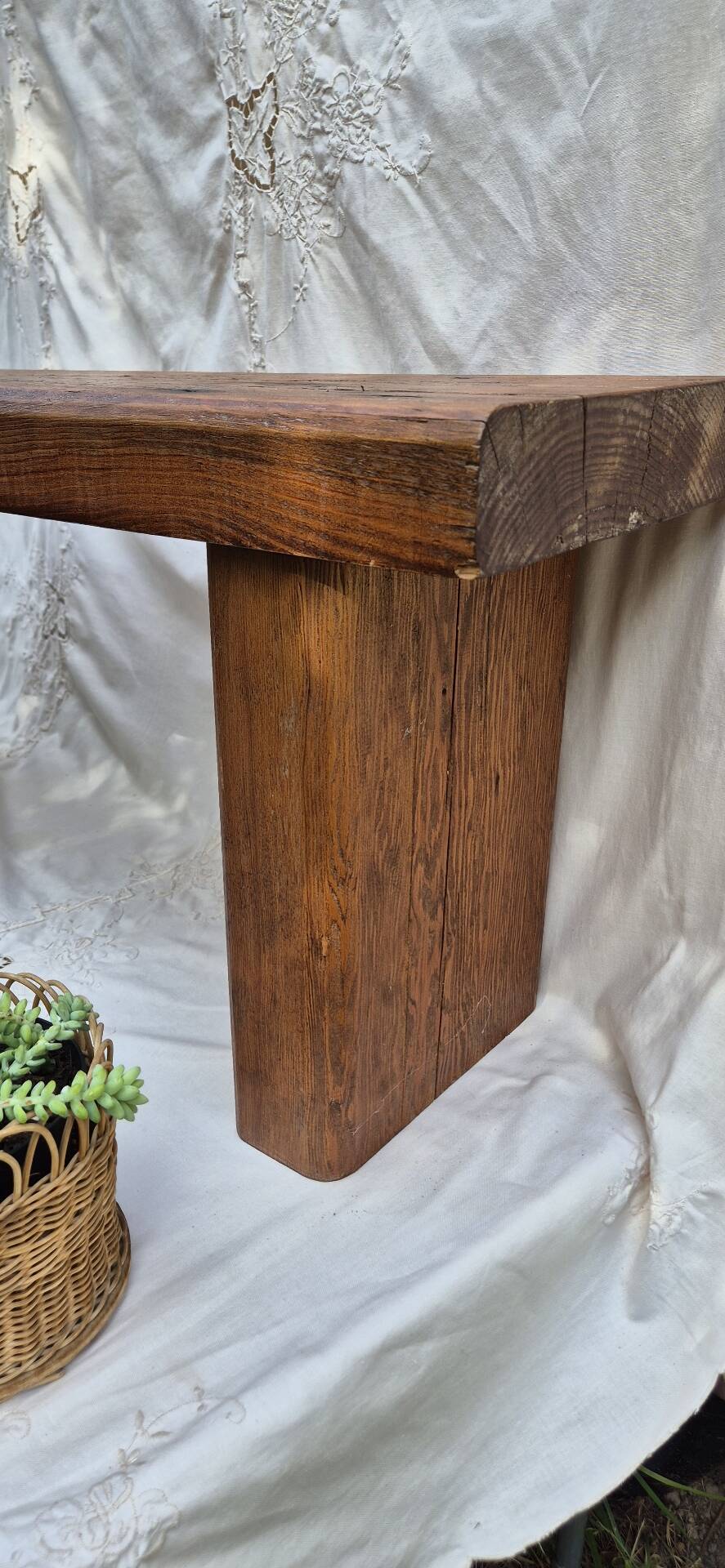 Brutalist wooden bench made of solid oak beam.