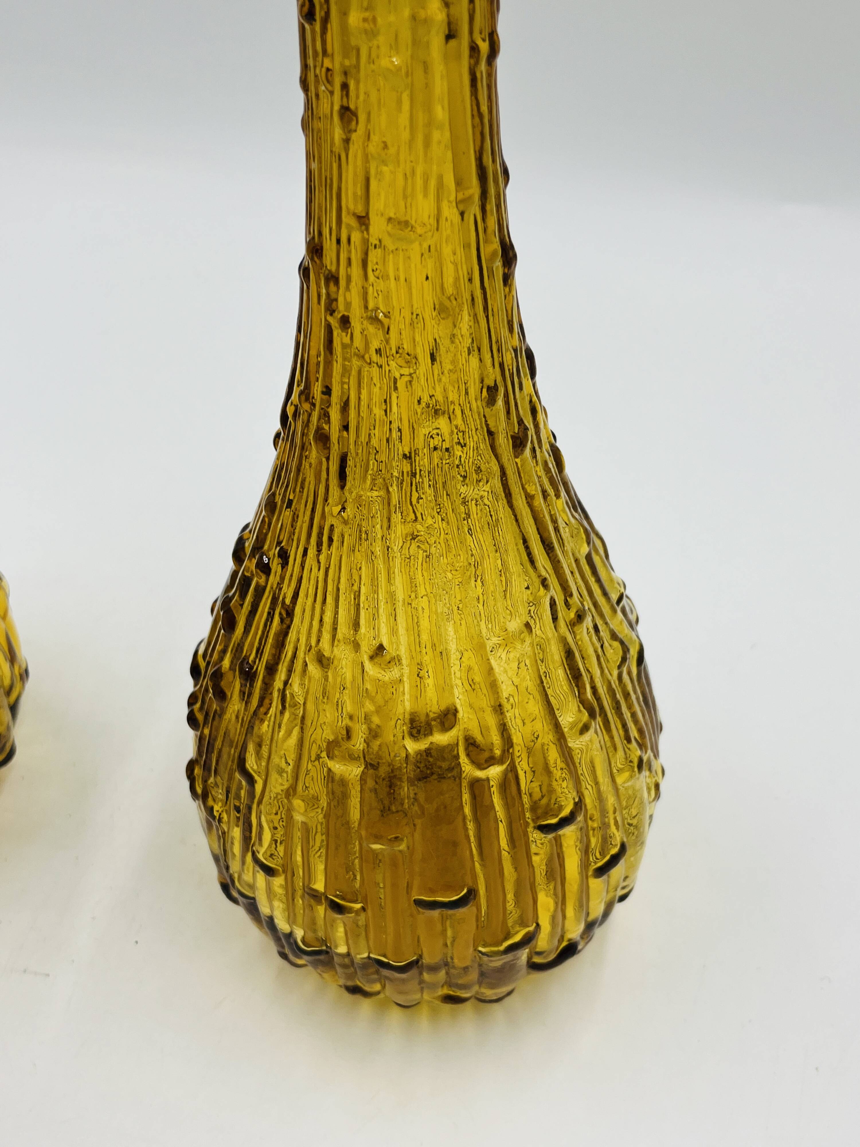 Set of two vintage textured amber glass Empoli bottles.