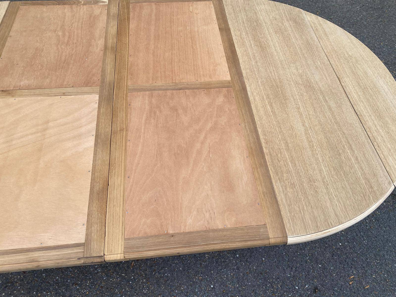 Round dining table with extendable leaves, Louis Philippe style, stripped in raw oak.