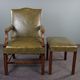 Elegant armchair and footrest in English green leather