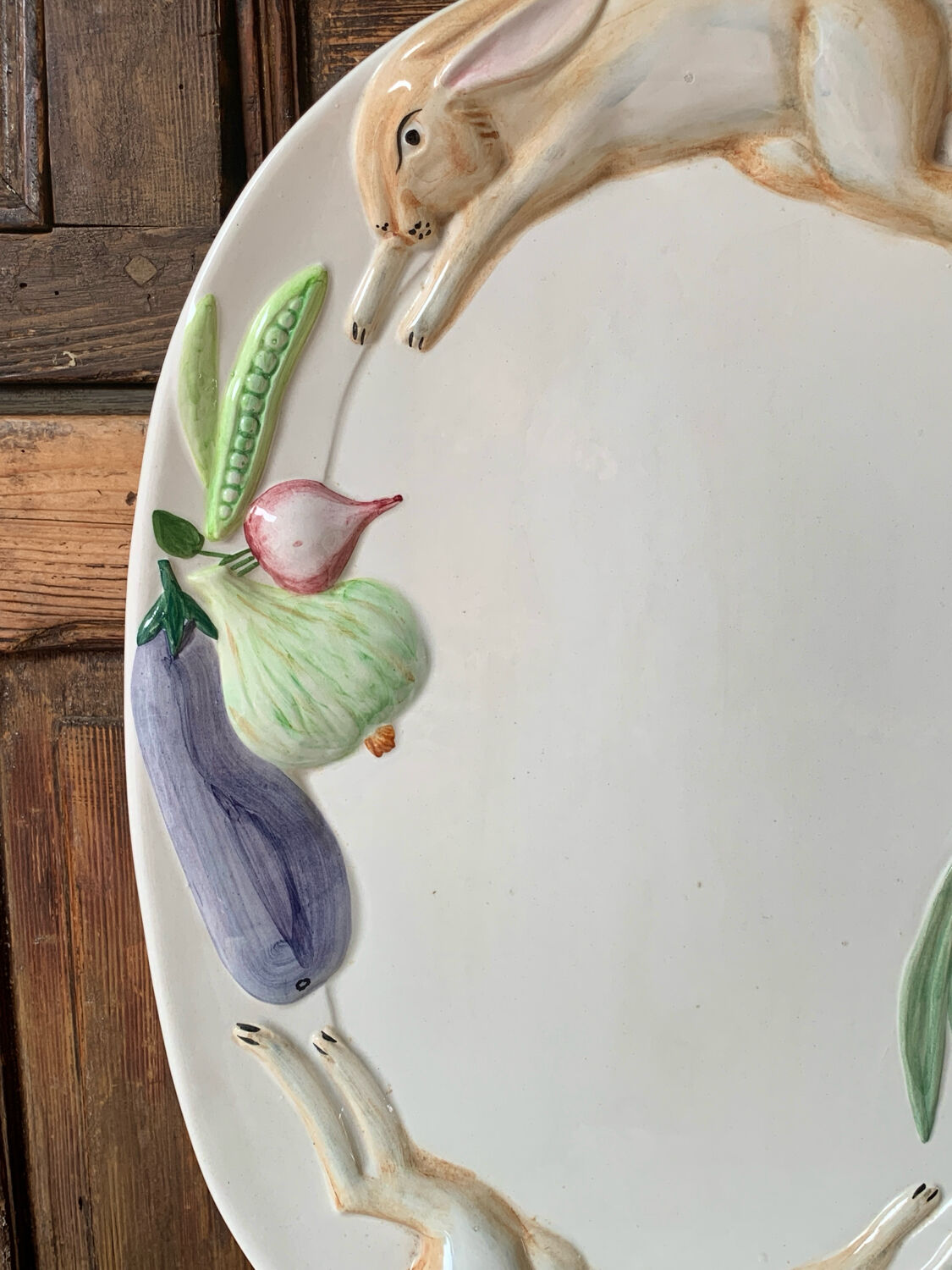 Very large serving dish with hares and vegetables.