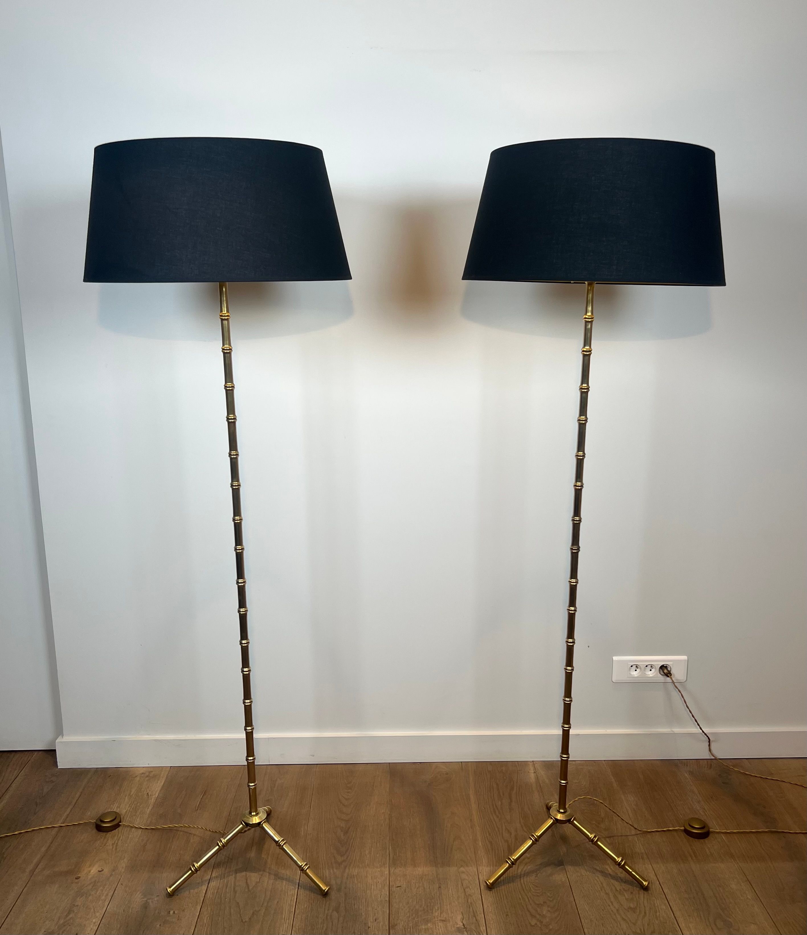 Pair of parquet floor lamps in faux-bamboo style in bronze and brass by Jacques Adnet.
