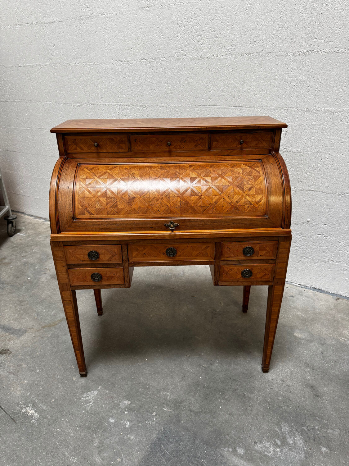 Cylinder desk with marquetry featuring a crosshatch design.