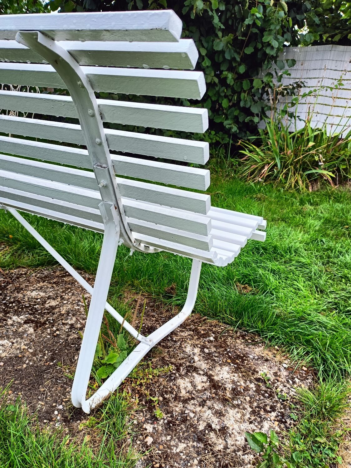 Antique garden bench with metal legs