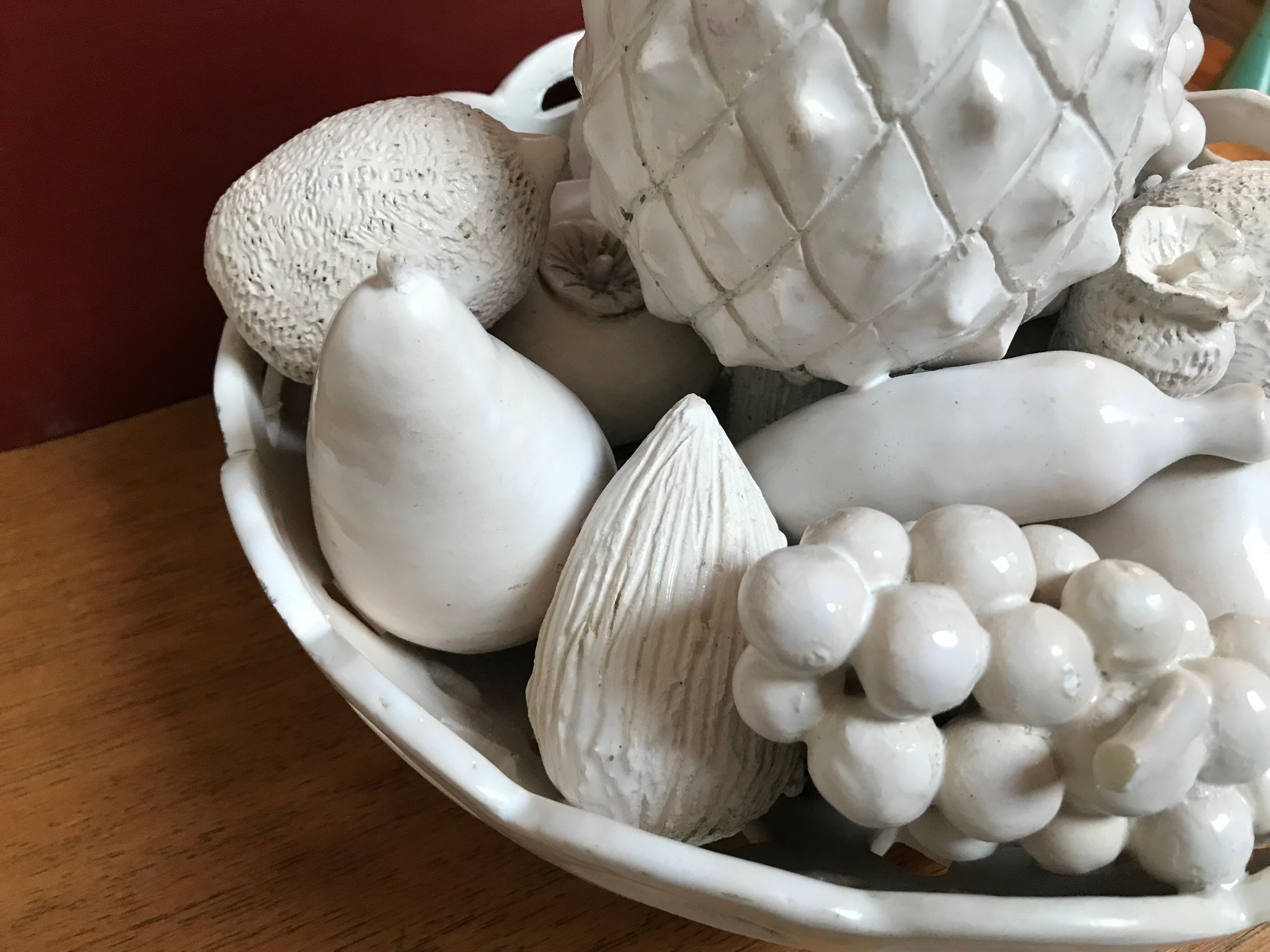 Trompe l'oeil fruit cut in white earthenware by Jean Roger, circa 1960.
