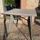 Pedestal table with airplane wing legs