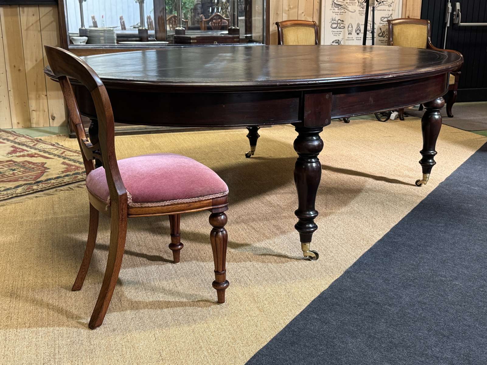 Large English library table in dark walnut with a leather top.