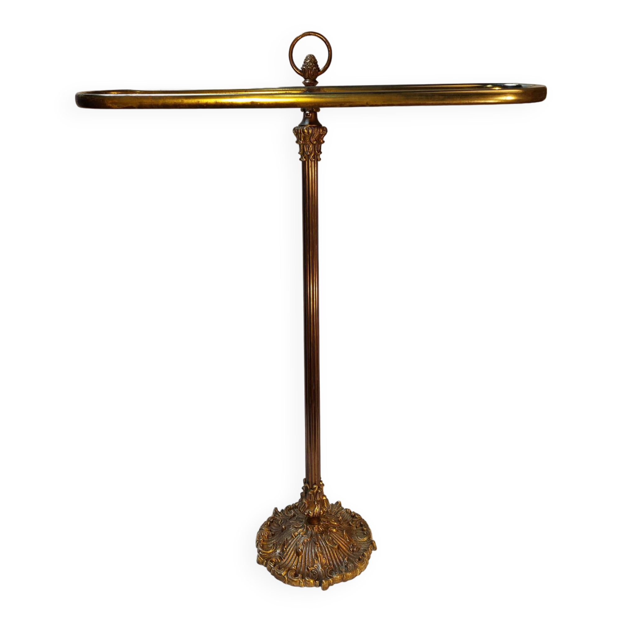 Old golden brass towel rack on baroque style foot