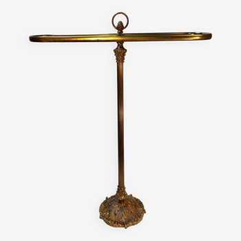 Old golden brass towel rack on baroque style foot