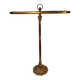 Old golden brass towel rack on baroque style foot
