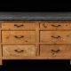 Old wooden workshop furniture with a stone top.