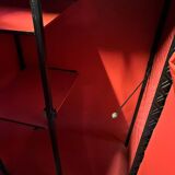 Contemporary wardrobe in black faux leather with diamond pattern and gold handles.