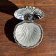Vintage silver-plated shell butter dish with transparent bowl.