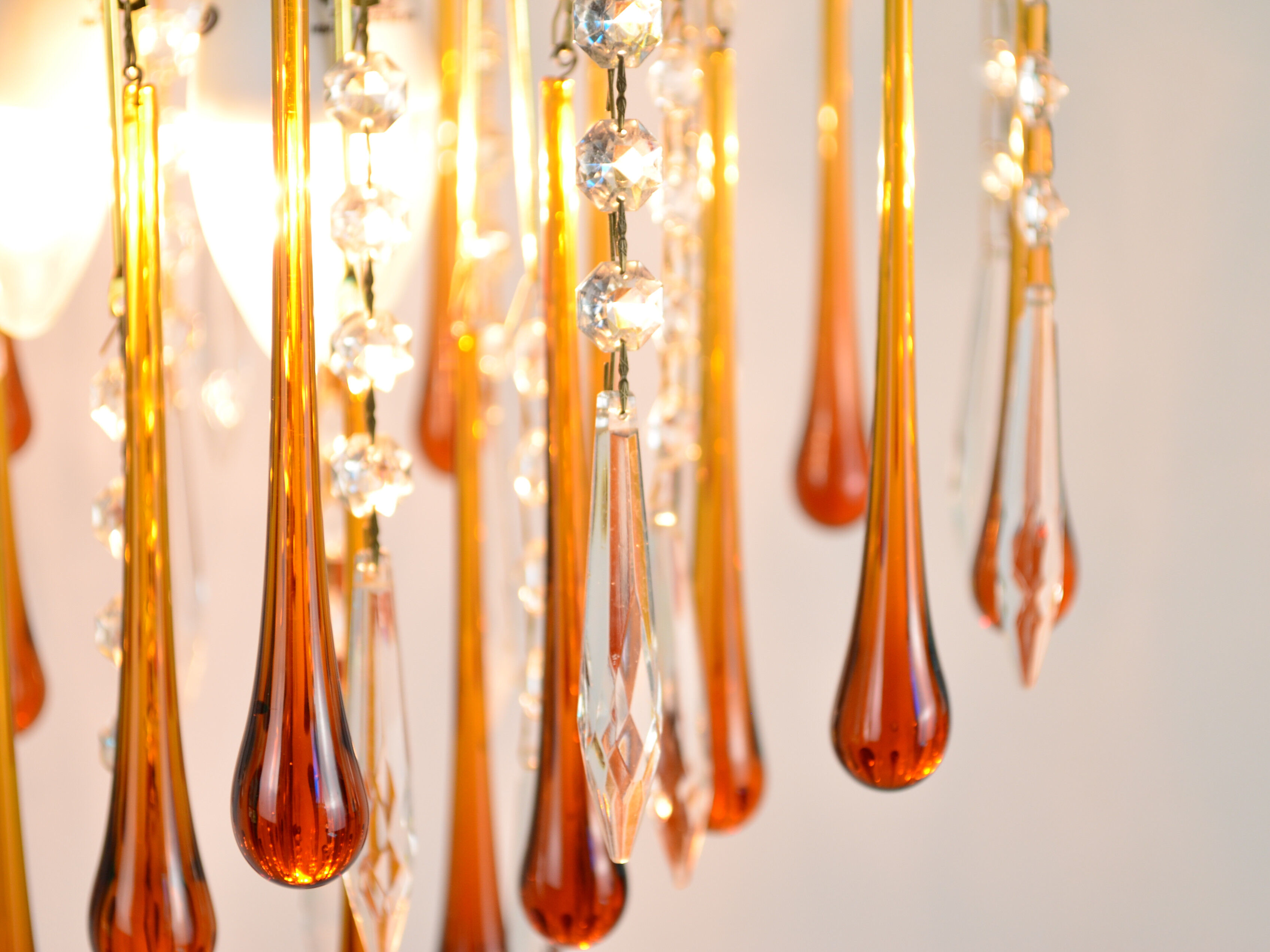 A pair of Mid Century 70's waterfall chandeliers. Murano glass amber drops. Paolo Venini style.
