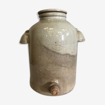 Old vinaigrier in sandstone vintage pot