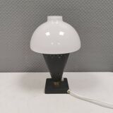 Small stylish table lamp with perforations and milky white opal glass shade